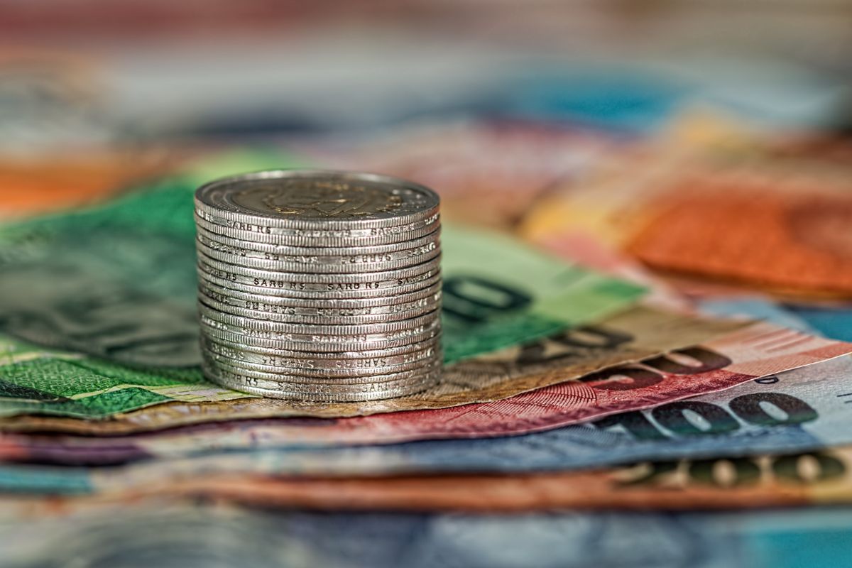 Stack of coins on banknotes